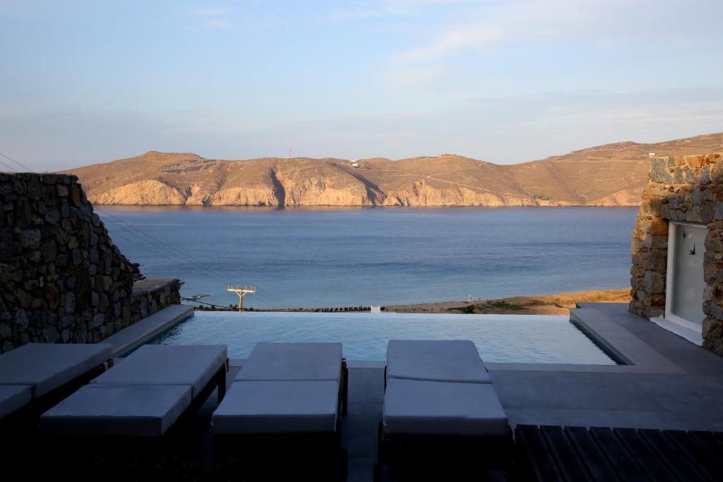 a swimming pool with a view of the water at Villa ANASA private Pool & Jacuzzi 8pax at Panormos in Mykonos