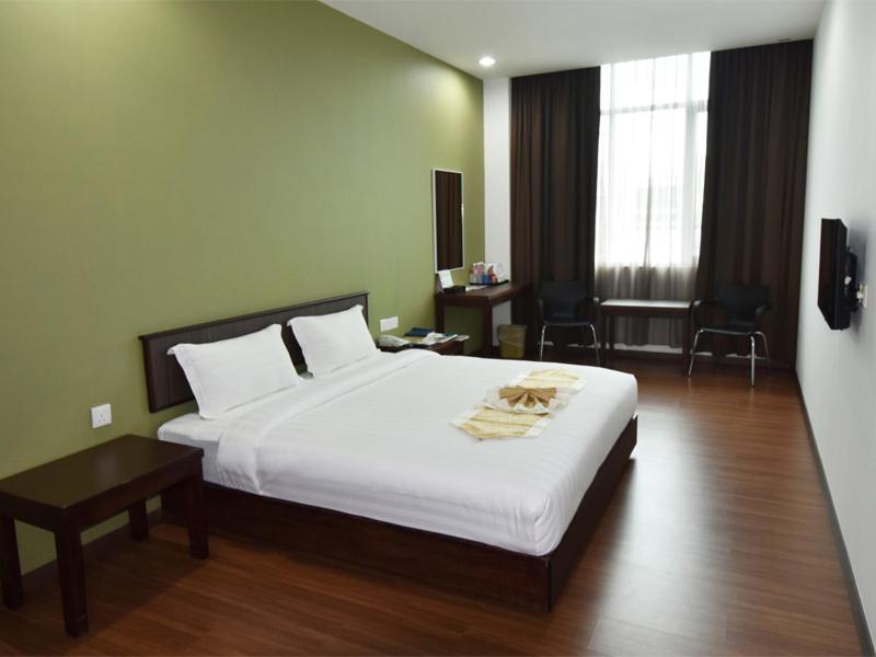 Postel nebo postele na pokoji v ubytování LI HUA HOTEL , BINTULU SENTRAL