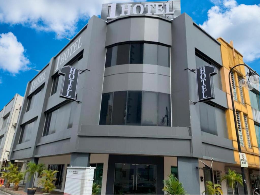 a building with a sign on top of it at 1 Hotel Kuchai Lama in Kuala Lumpur