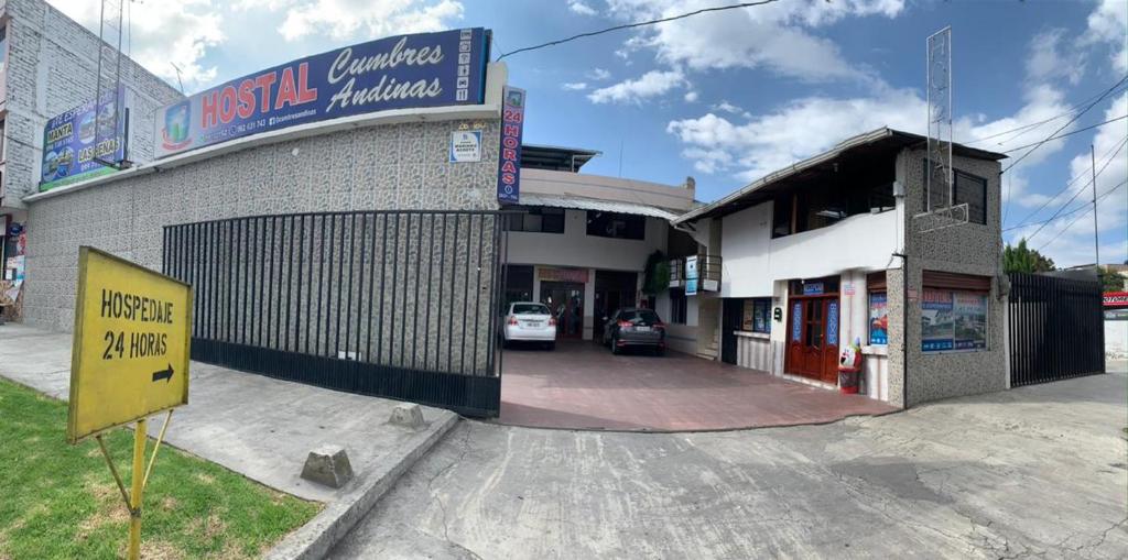 a building with a sign on the side of it at Hostal Cumbres Andinas in Ibarra