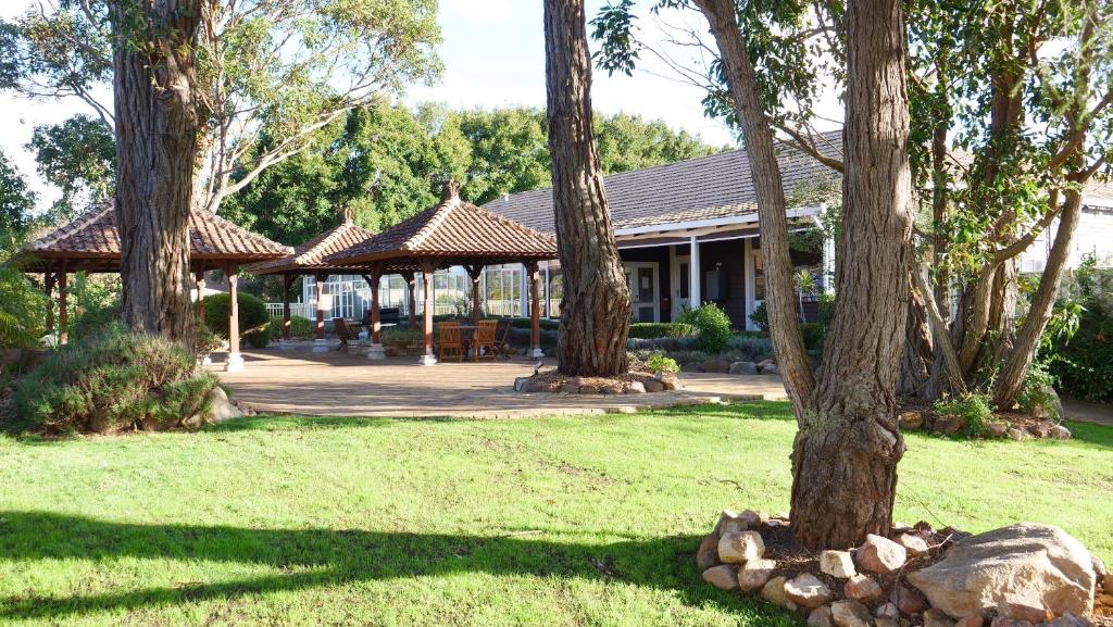a house with trees and a gazebo at Margaret River Motel in Margaret River Town
