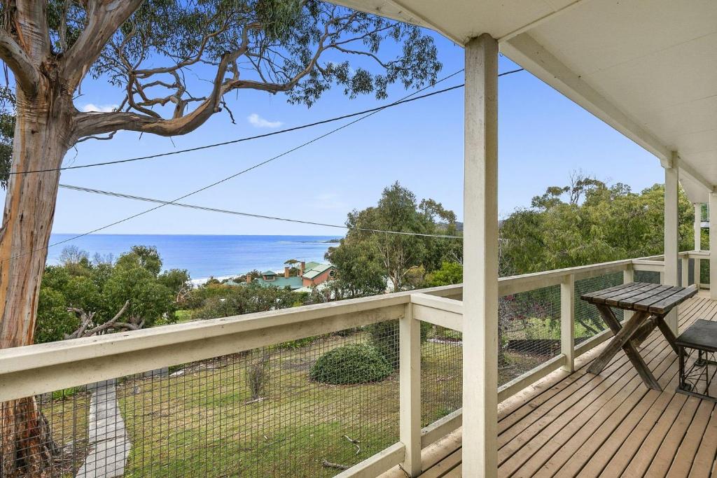 a view from the deck of a house with a tree at Retro Retreat in Lorne