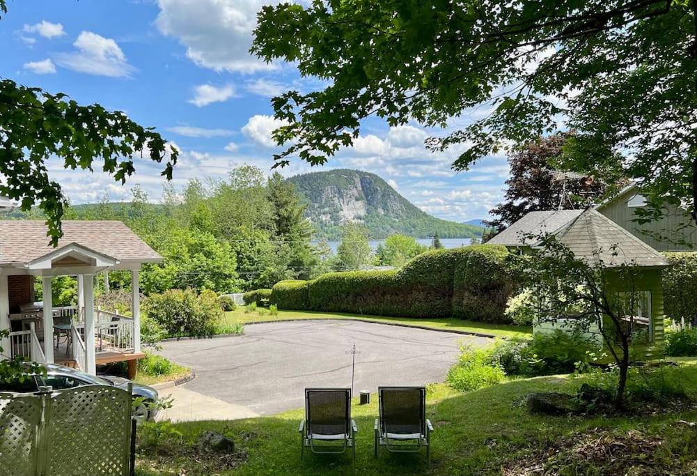 two chairs sitting in the yard of a house at Newly Renovated villa with magnificent views in Coaticook