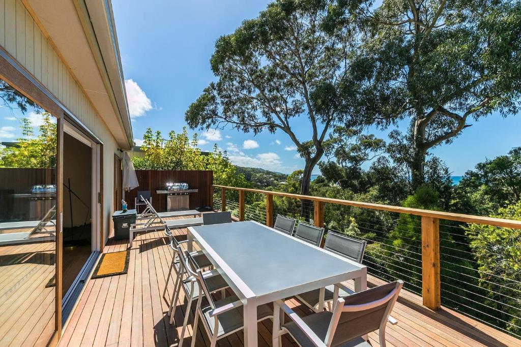 a patio with a table and chairs on a deck at Strathlea in Lorne