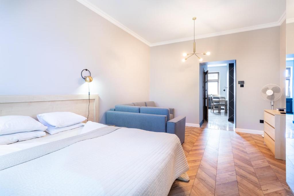Posteľ alebo postele v izbe v ubytovaní Apartamenty Łazarza 17