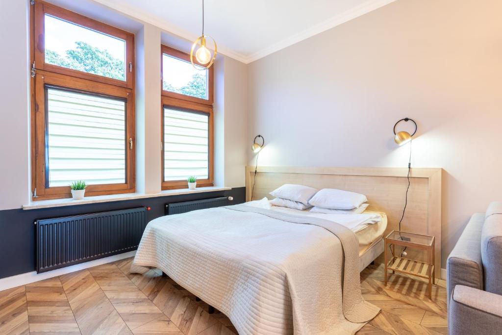 Posteľ alebo postele v izbe v ubytovaní Apartamenty Łazarza 17