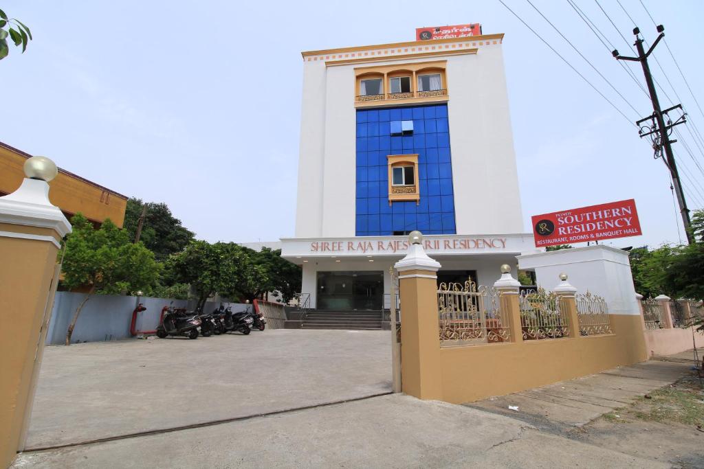 a blue and white building with a gate in front at Pondy Southern Residency in Puducherry