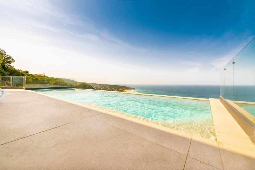 a swimming pool with a view of the ocean at Villa El Buzo in Zahara de los Atunes