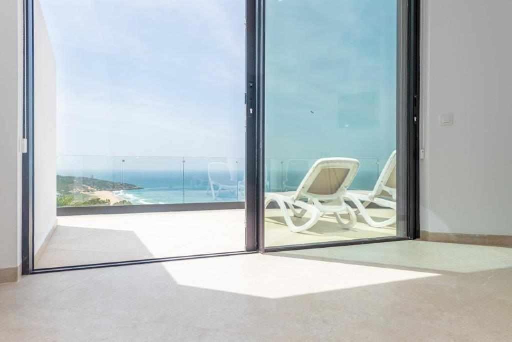 a room with two chairs and a view of the ocean at Villa El Buzo in Zahara de los Atunes