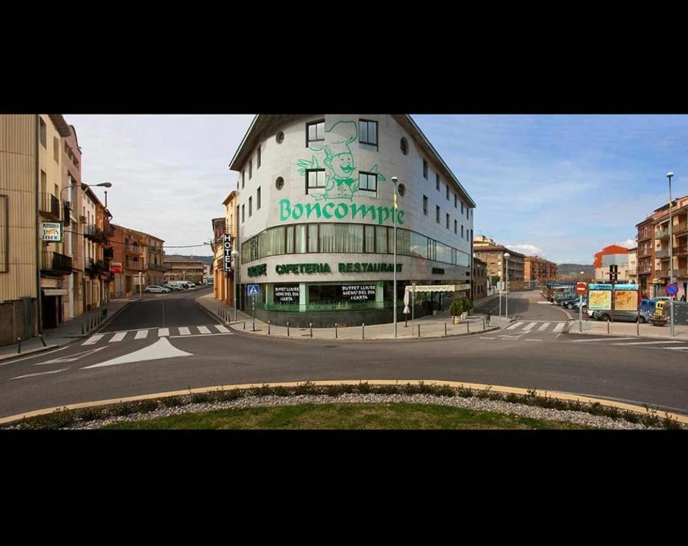 a building with a sign on the side of it at Hotel BONCOMPTE in Ponts