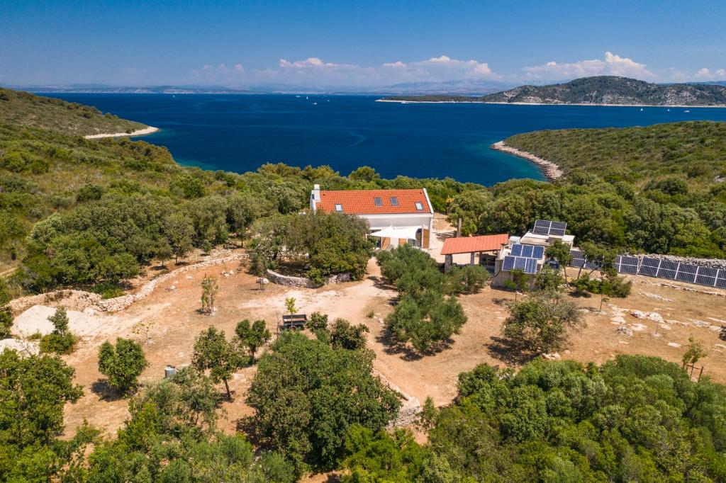 an aerial view of a house on the shore of a lake at Hvar Cricket House Pakleni island in Hvar