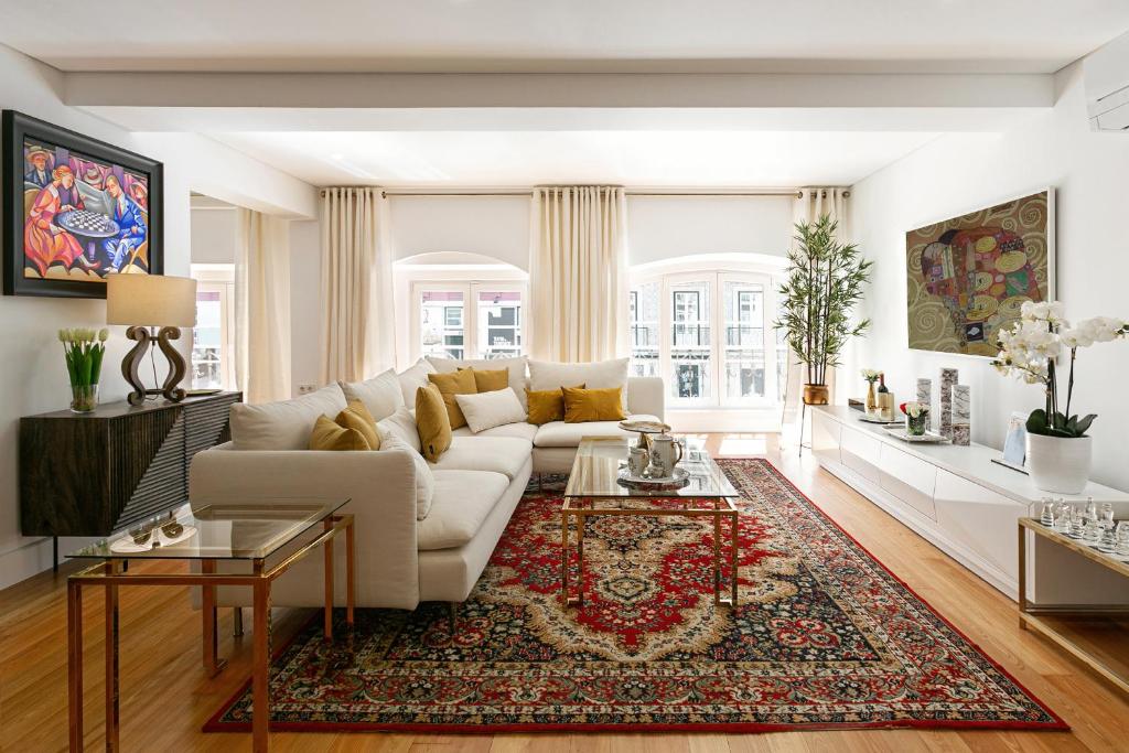 a living room with a white couch and a rug at Lisbon Rentals Chiado in Lisbon