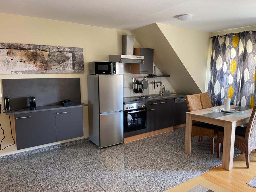 Kuchyň nebo kuchyňský kout v ubytování Hotel Mythos "Apartments"