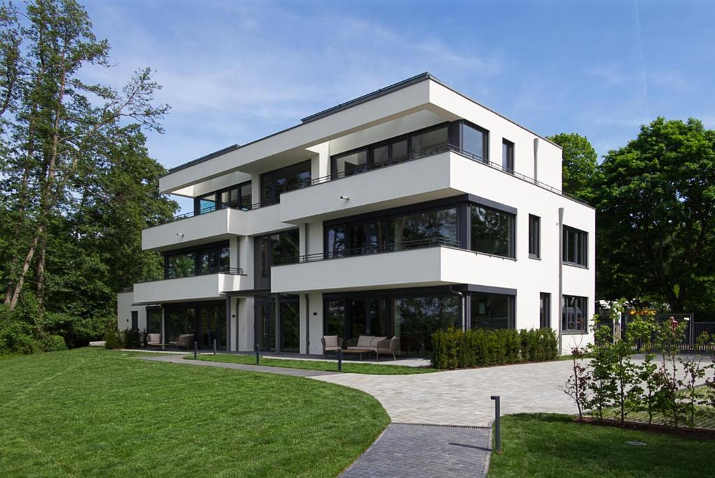 a white house with a lot of windows at Gerono - Haus am See in Wusterwitz