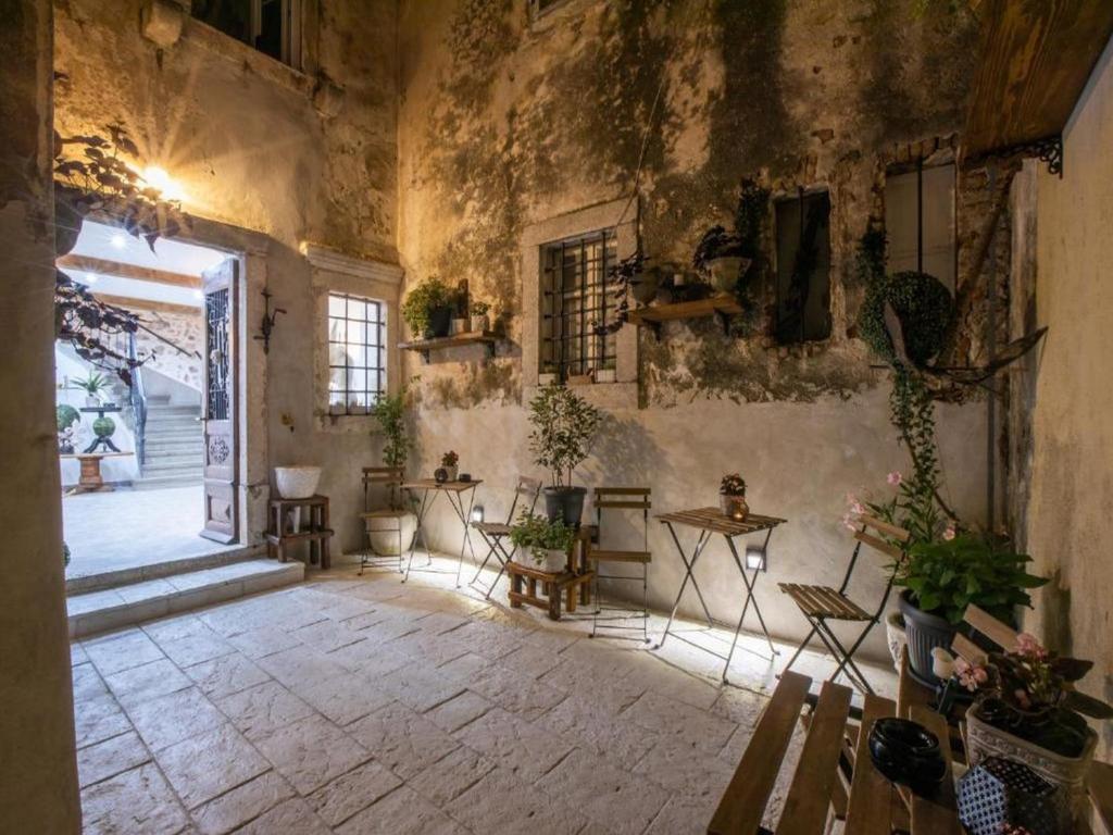 a room with tables and chairs in a building at History House Moja Ti 1830 in Old Town Senj in Senj