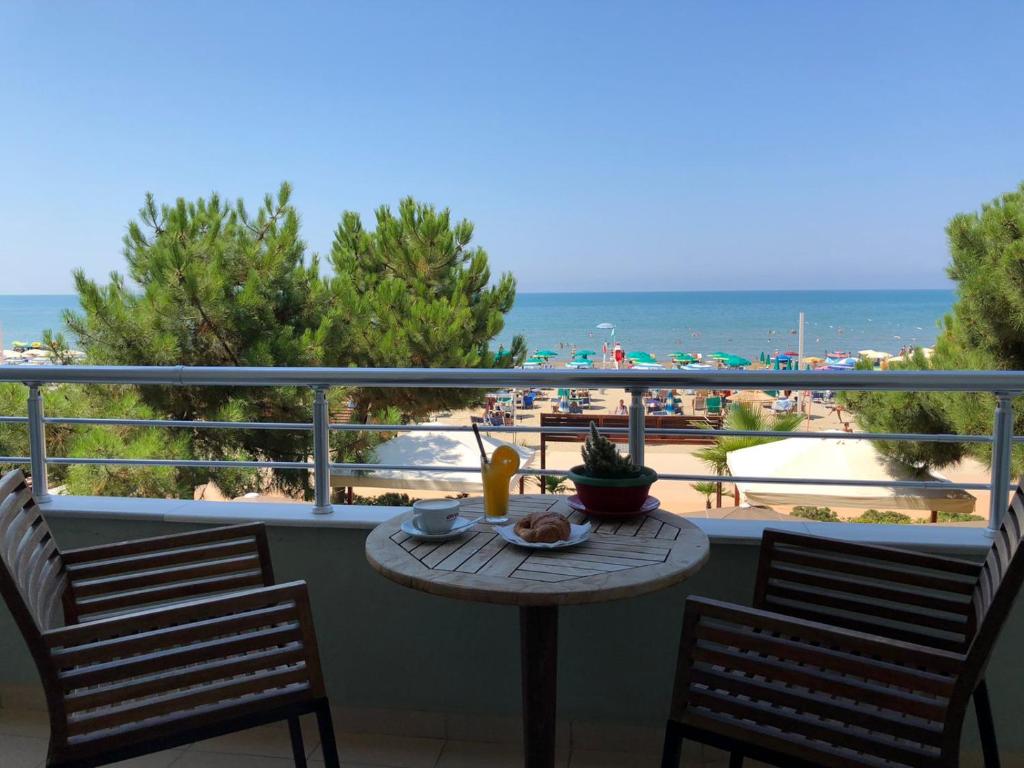 a table on a balcony with a view of the beach at RUMAR HOTEL in Durrës