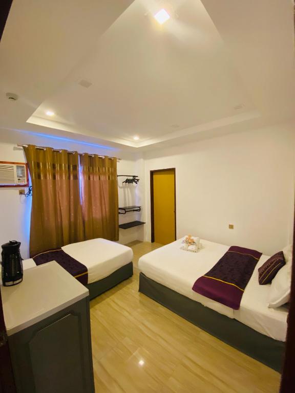 Postel nebo postele na pokoji v ubytování Mirage Suites de Boracay