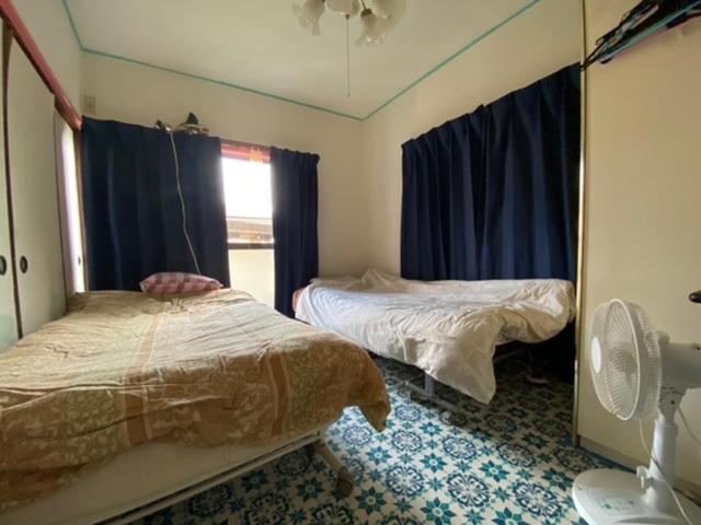 Postel nebo postele na pokoji v ubytování メゾン102号 Mason Guest House Suite 102