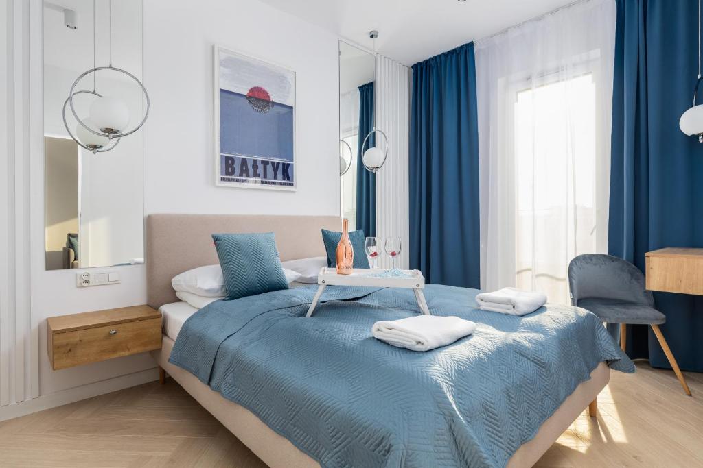 een slaapkamer met een bed met een tafel erop bij Baltic Marina Residence Apartments by Renters in Kołobrzeg