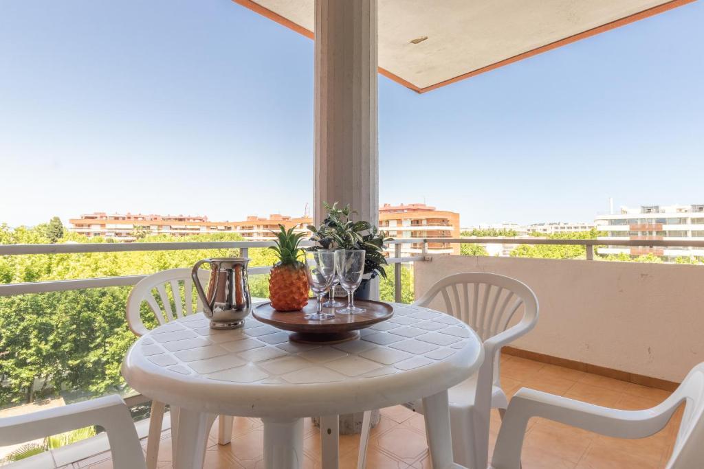 a white table with a pineapple on a balcony at Apartamento Cerdeña Arysal in Salou