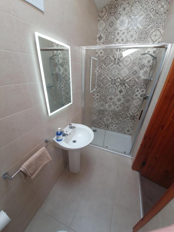 a bathroom with a toilet, sink, and tub at Slane Farm Hostel, Cottages and Camping in Slane