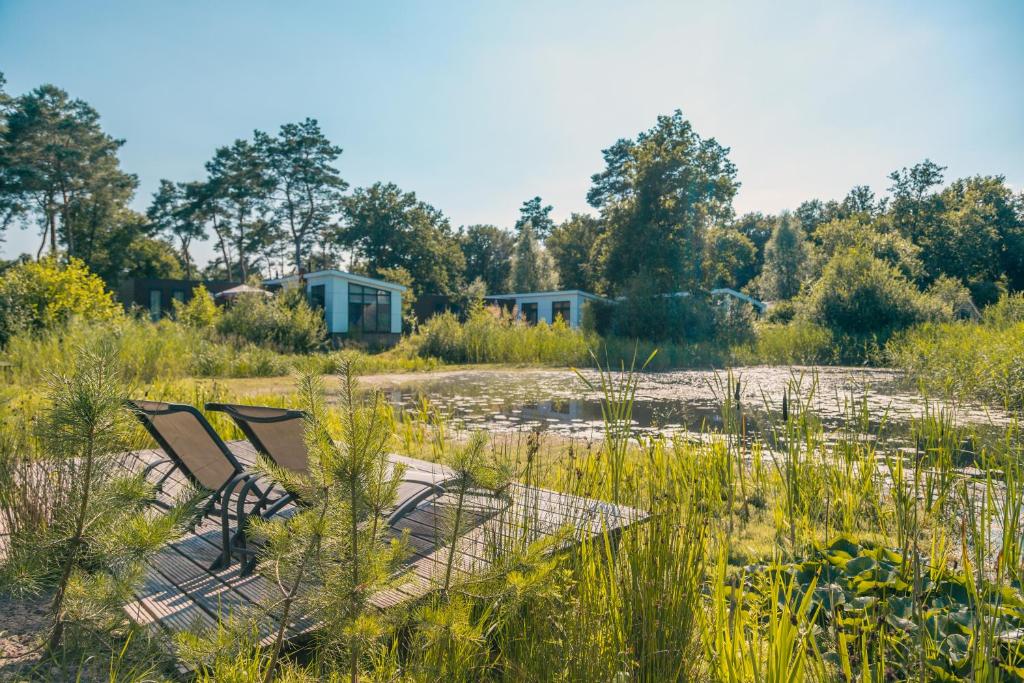 zwei Stühle in der Mitte eines Feldes in der Unterkunft EuroParcs Reestervallei in IJhorst