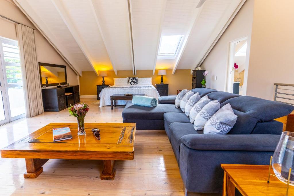 a living room with a blue couch and a table at TheLoft32 in Cape Town