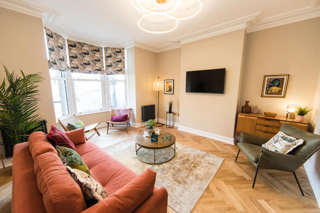 a living room with a couch and a table at Maison Mouettes by Maison Parfaite - Luxury Suites with Abbey Views in Whitby