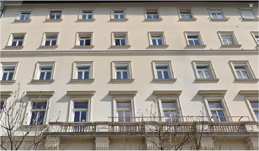 a large white building with windows and a balcony at B3 Hostel Budapest in Budapest