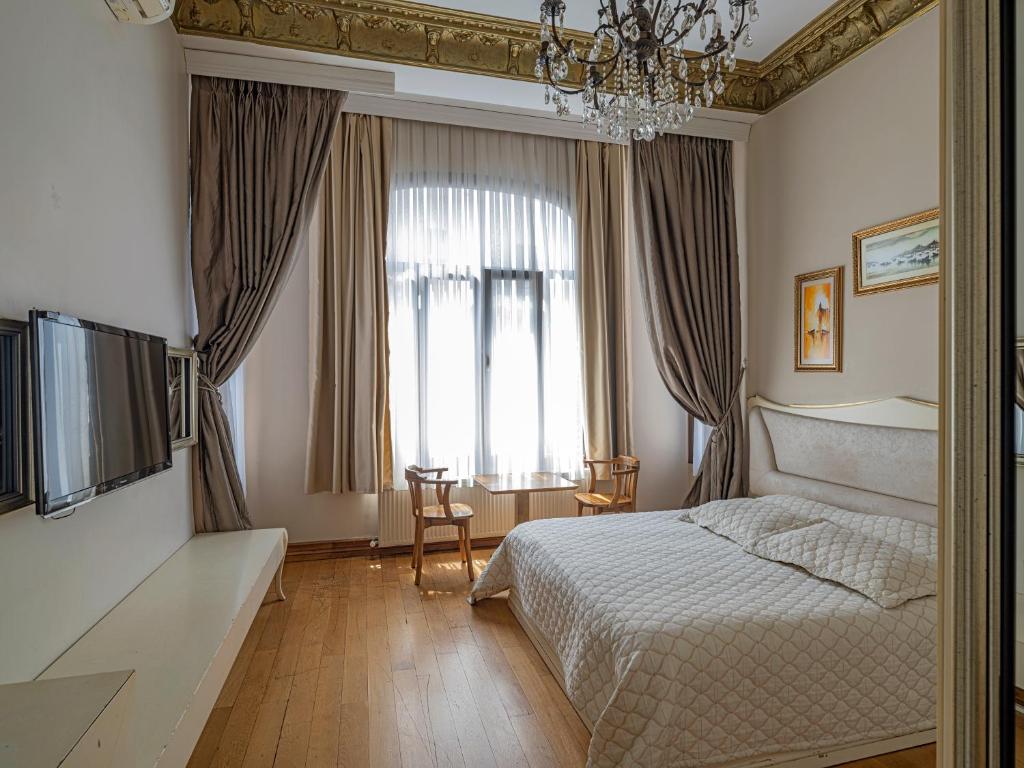 a hotel room with a bed and a window at Ragip Pasha Apartments in Istanbul