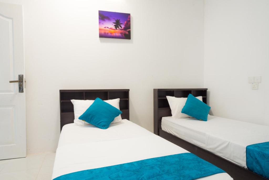 Postel nebo postele na pokoji v ubytování Palm Gate Maldives