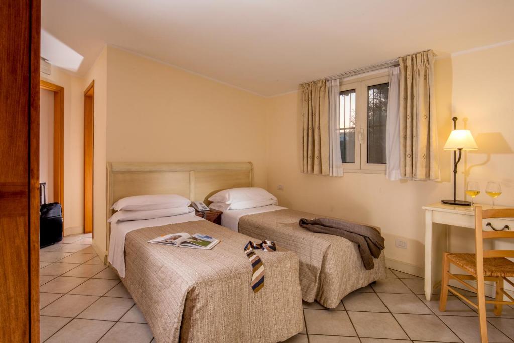 Postel nebo postele na pokoji v ubytování Hotel Selva Candida