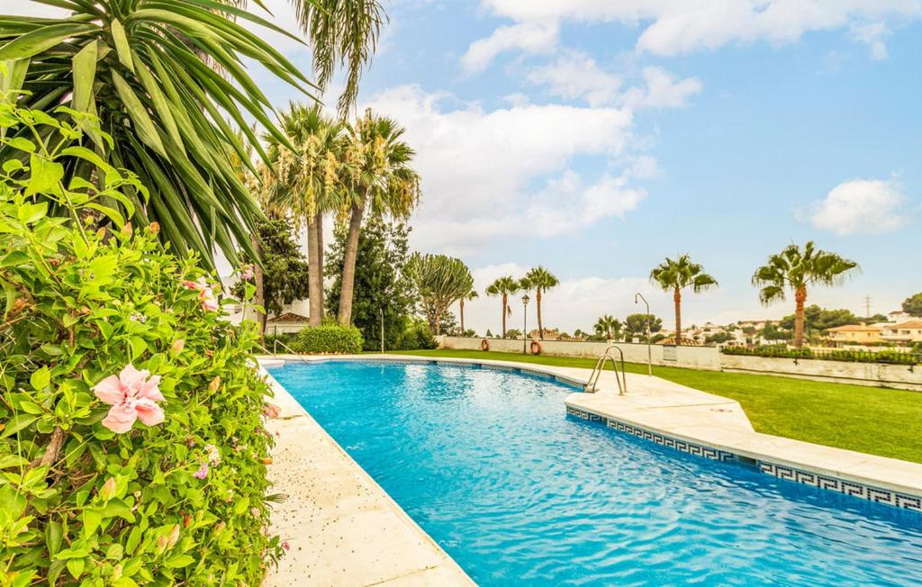 a swimming pool in a yard with palm trees at Mirador de Calahonda 80 in Mijas