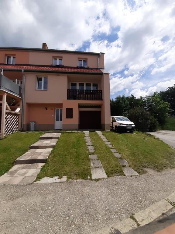 a house with a car parked in front of it at Černá v Pošumaví Apartmán in Černá v Pošumaví