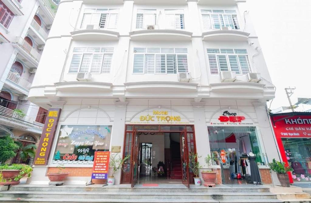 a white building with a sign in front of it at Nhà nghỉ Đức Trọng in Móng Cái