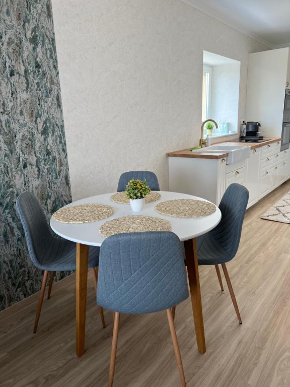 a kitchen with a table and chairs and a sink at Lakeside Home in Siófok