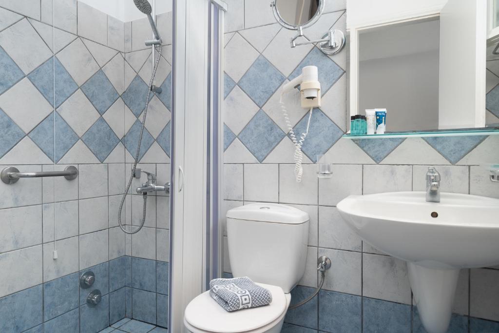 a bathroom with a toilet and a sink at Astir Of Naxos in Naxos Chora