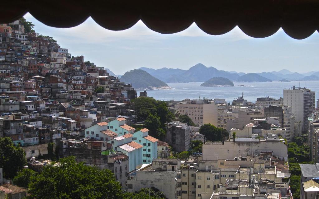 a view of a city with buildings and the ocean at Pousada Favela Cantagalo in Rio de Janeiro