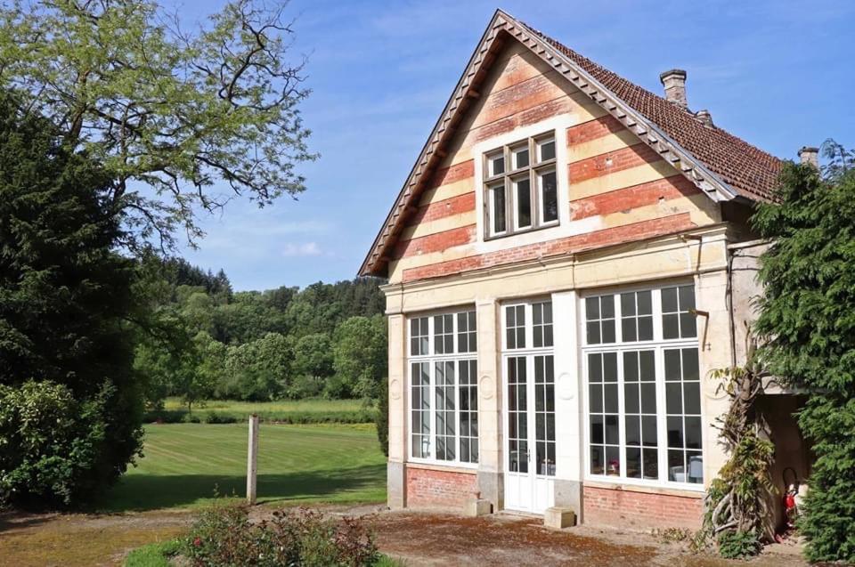 a house with a large window on the side of it at L'Orangerie in Cahan