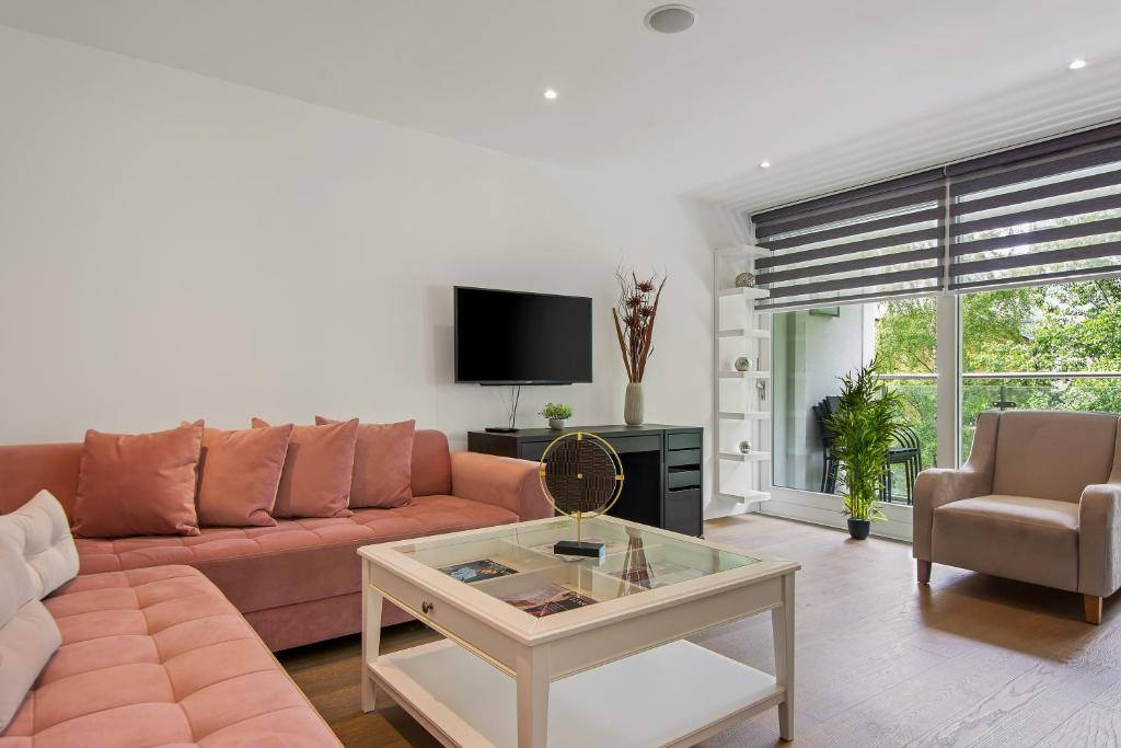 a living room with a couch and a table at Three Bedroom Serviced apartment in Old Street in London