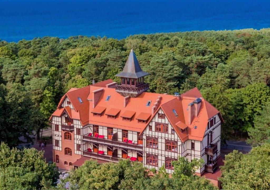 an aerial view of a building with a tower at KAISERHOF Krynica Morska in Krynica Morska