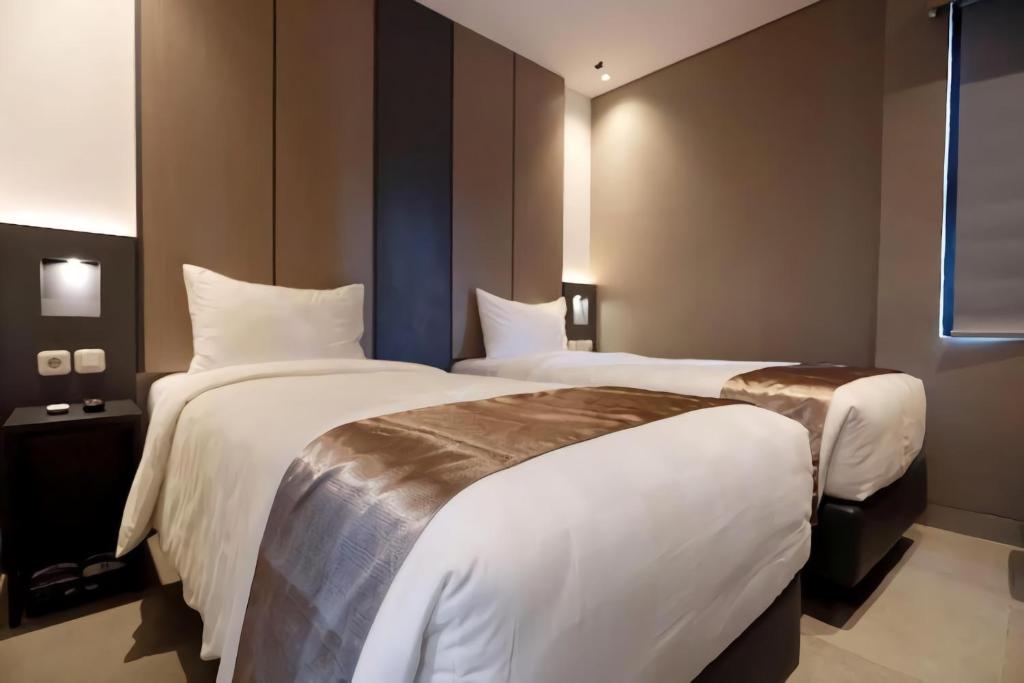 Postel nebo postele na pokoji v ubytování Hayo Hotel Palembang