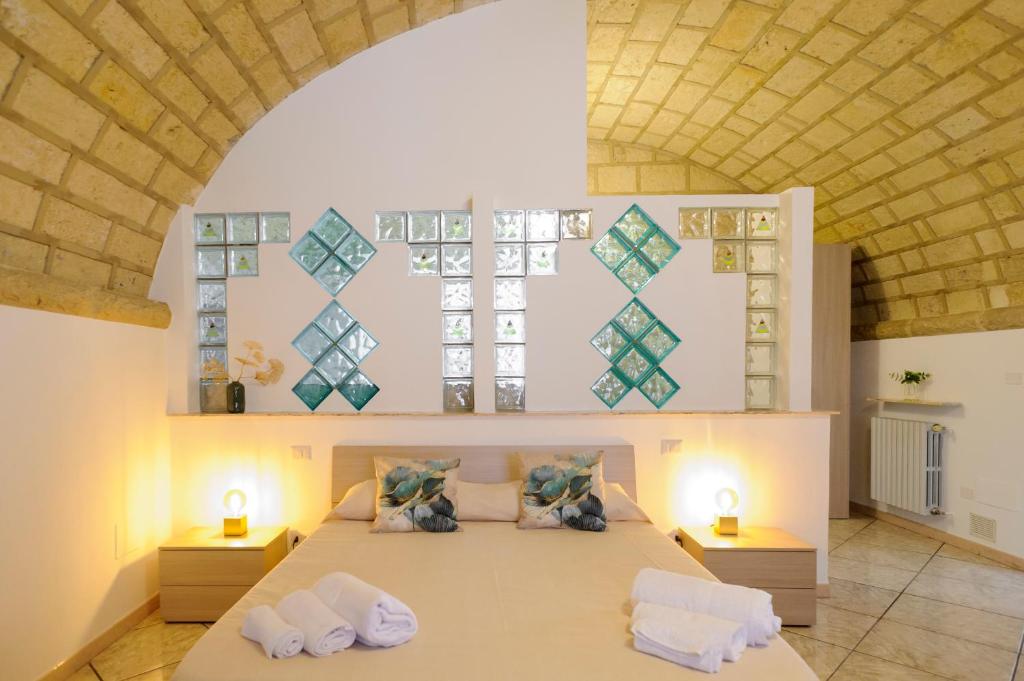 a bedroom with a large bed with two pillows at Villa Franca in Bari