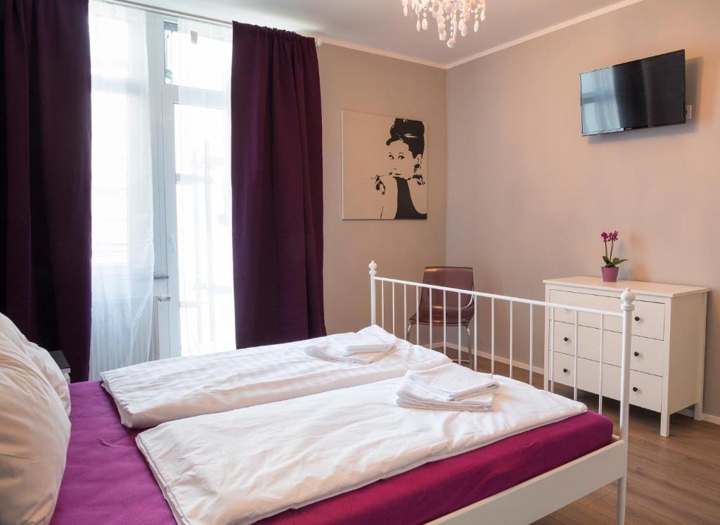 a bedroom with a white bed and a window at Hotel Forty Four in Frankfurt