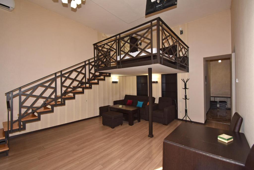 a living room with a staircase and a couch at Apartment Koryun 1 in Yerevan