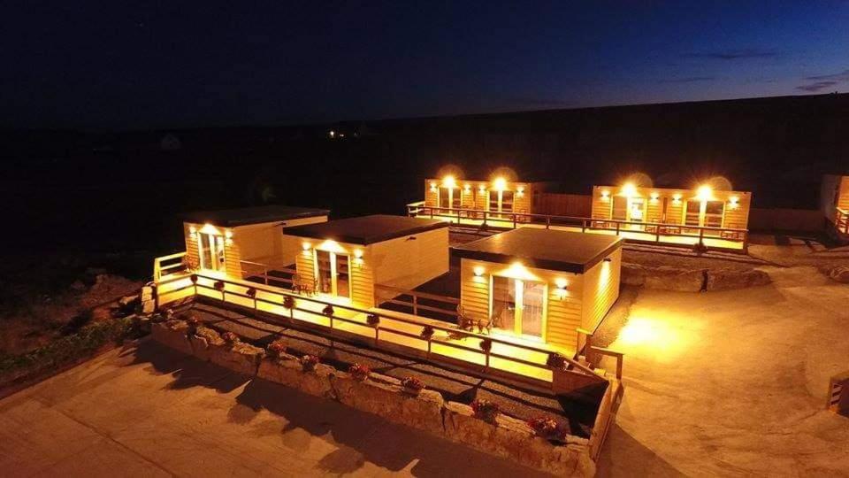a hotel room with a balcony overlooking the ocean at Aran Islands Hotel in Kilronan