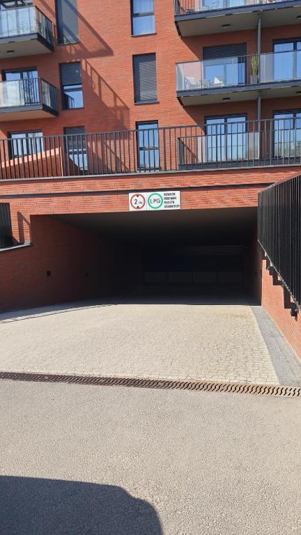 a parking garage in front of a building at Old Town Nadmotławie - Sauna & Gym I 10min deptak in Gdańsk