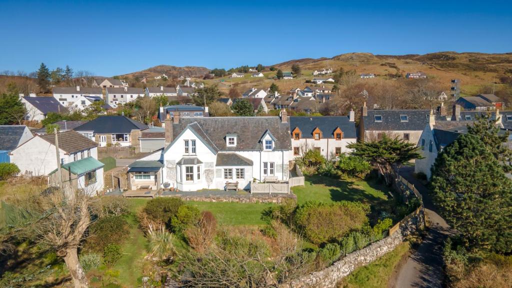 an aerial view of a house on a hill at The Old School House B&B in Gairloch