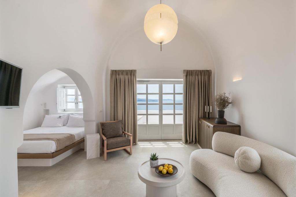 a living room with a bed and a couch at Aspaki by Art Maisons in Oia