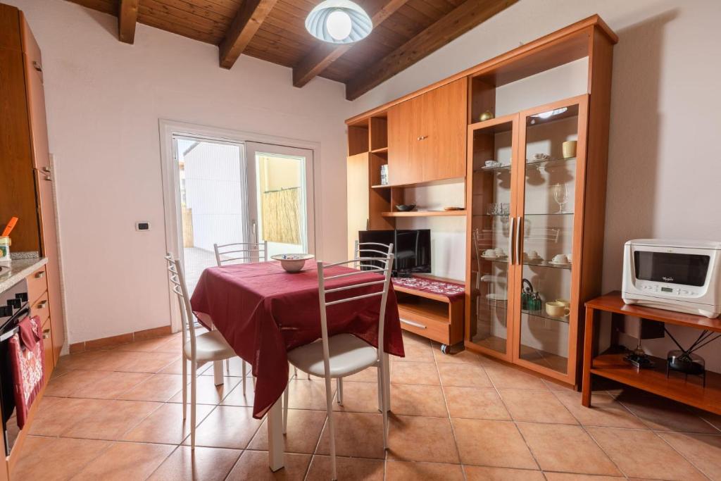 a kitchen with a table and chairs in a room at GaLi eco-apartment in Olbia